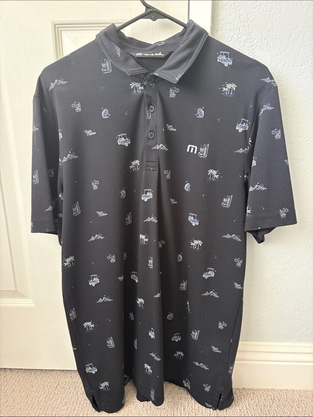Travis Mathew Black Polo with White Tropical Icons